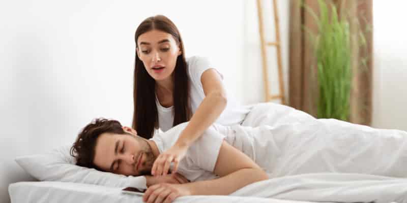 Jealous Woman Taking Husband's Phone While He Sleeps In Bedroom