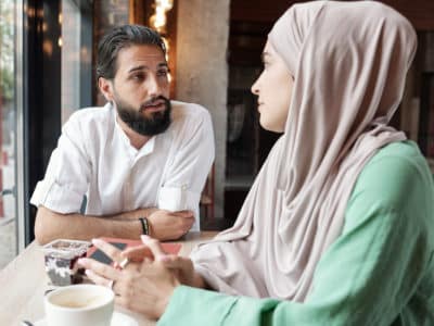Muslim Couple In Modern Cafe